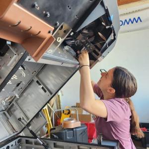 A person working on a tilted machine.