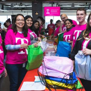 Volunteers packing colorful bags in two lines.