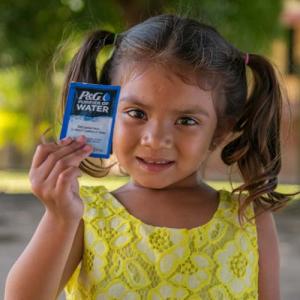 girl holding P&G water packet