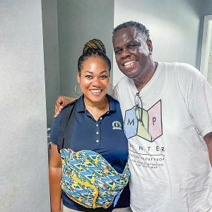 two people in a hall way, one wearing a "MAP center" tshirt