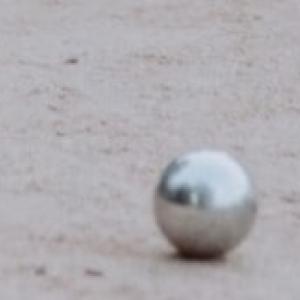 three silver marbles on the ground