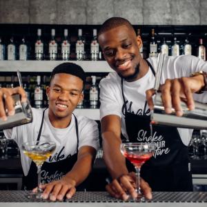 two men pouring drinks