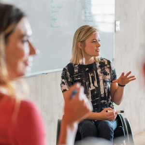 Women meeting with white board in background