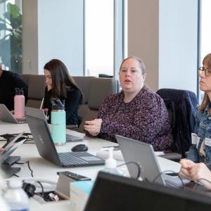 6 people pictured at a meeting