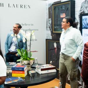 a room of people looking at displays on the walls