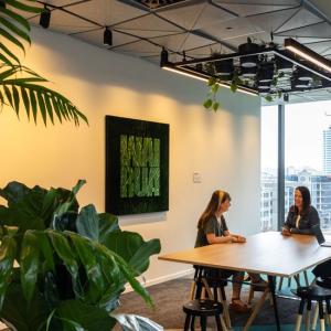 meeting room with three people meeting