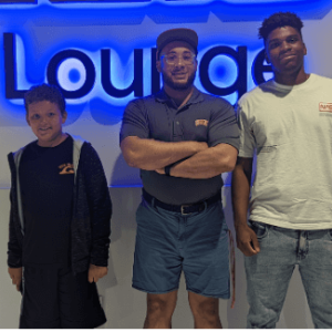 3 people standing in front of a "lounge" sign