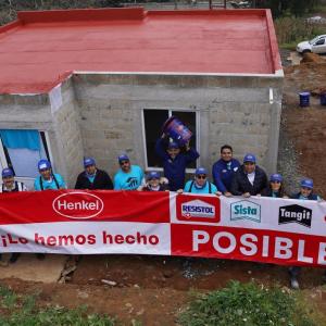 Overhead shot of people holding Henkel banner