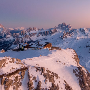 Building on a high mountain top at sunset