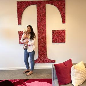  Logan Mcintosh and Brooke in front of a large T on a wall.