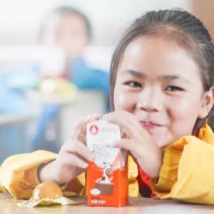 Girl drinking milk and smiling