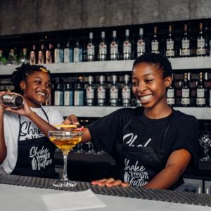 two women mixing drinks