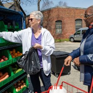 People choosing produce outside
