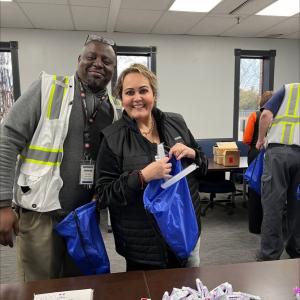 two volunteers packing blue sacks
