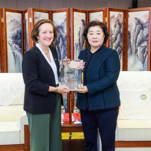 two women holding plaque 