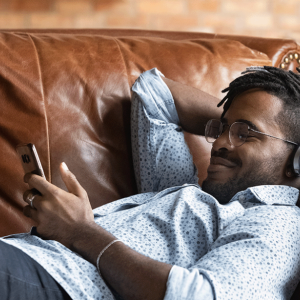 Mobile phone user unwinding on the sofa