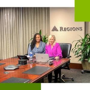 Shayla and Kristi sitting together sharing a computer