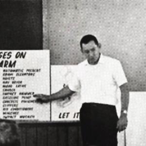 An old photo, a representative from Duke Power giving a presentation to a group of children about motor uses on the farm