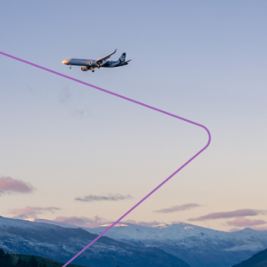 A plane in flight over mountain terrain.