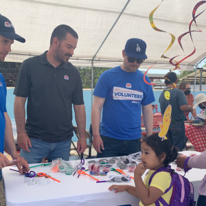 a group of marathon volunteers at a table, a child and adult on the other side
