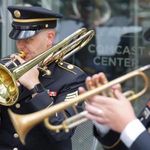 Two members of the armed forces playing brass instruments
