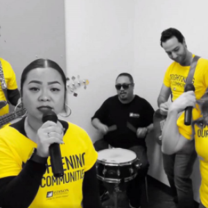 A band with singer, guitar, drum players.