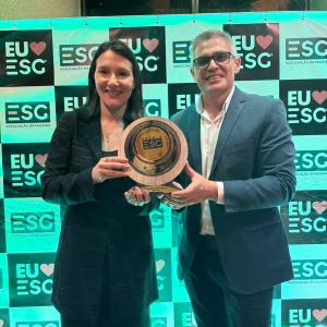 two people holding award at event