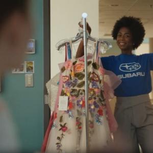 people with rack of dresses