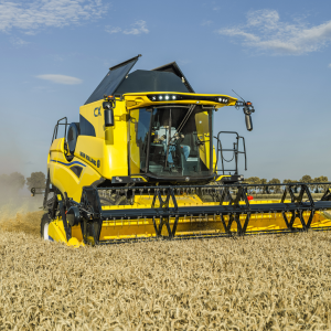 Yellow machine in action in a field