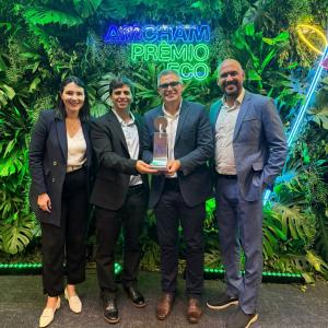 four people holding an award