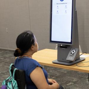 person at Self-Ordering Kiosk