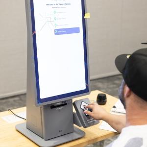 person at Self-Ordering Kiosk