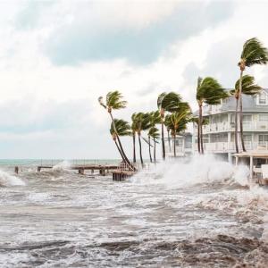 Stormy seas next to apartment buildings