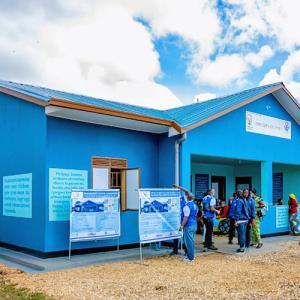 a bright blue building, people coming in and out