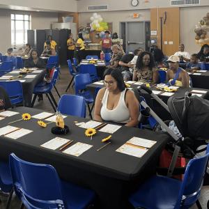 A group of people seated in a decorated room.
