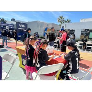Three children writing at a table