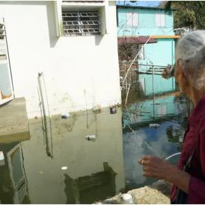 Elderly residents return to the Parcelas Selgas neighborhood of Florida, Puerto Rico, to find their homes still underwater, more than three weeks after Hurricane Maria made landfall. (Lara Cooper/Direct Relief)