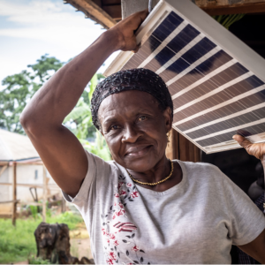 Woman carries a solar panel over her head