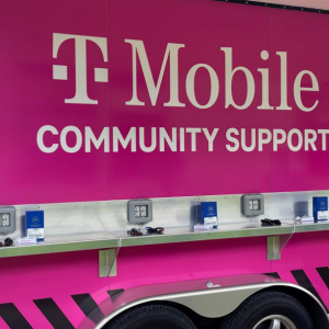 TMobile logo on the side of a pink vehicle "community support" equipped with charging ports