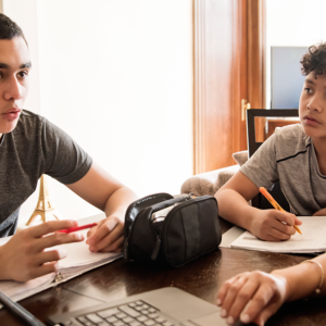 Students sitting around a laptop