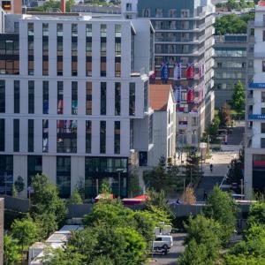 Aerial view of a tree-lined area with multiple tall buildings.