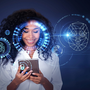 A smiling person using a tablet device. Digital face and fingerprint scans super imposed.