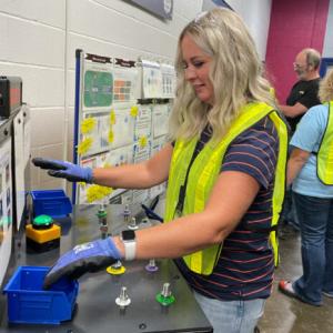 Teacher wearing gloves and yellow vest 
