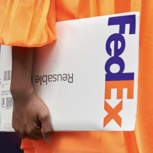 person holding a FedEx package