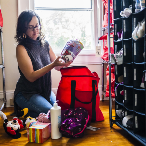 Becky packing a red bag with supplies.