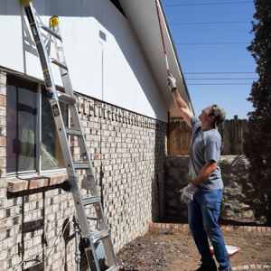 Volunteer painting a house