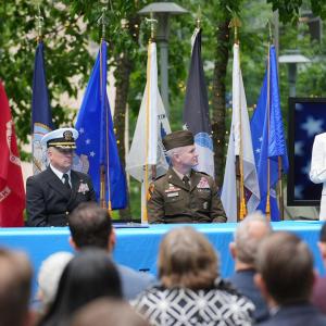 Comcast team members and members of the armed onstage at an event.