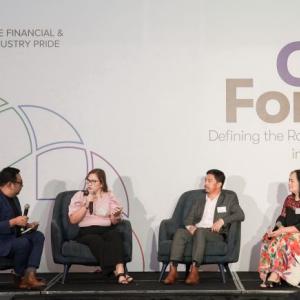 Four people in chairs on a stage, one with a microphone. Large "PFIP CEO Forum" sign behind them.
