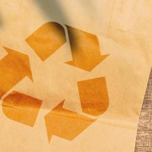 A brown paper bag with a recycling logo on it.