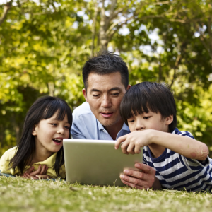 parent and children on a laptop